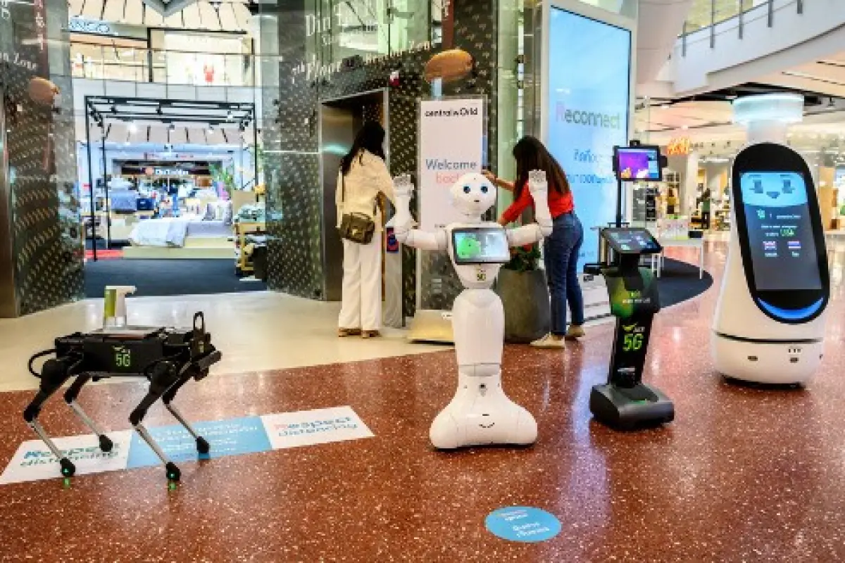 5G robots welcome visitors to a shopping mall in Bangkok on June 4, 2020, as sectors of the economy reopen following restrictions to halt the spread of the COVID-19 novel coronavirus. (Photo by Mladen ANTONOV / AFP)