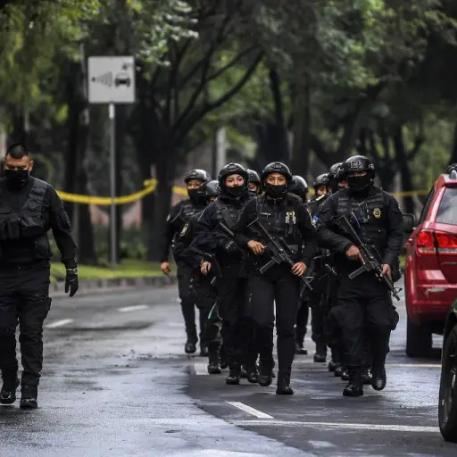 Police officers are deployed after Mexico City's Public Security Secretary Omar Garcia Harfuch was wounded in an attack in Mexico City, on June 26, 2020. (Photo by PEDRO PARDO / AFP)