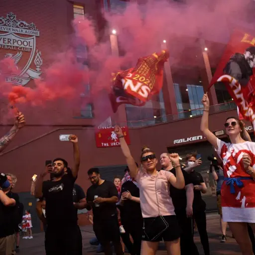 Fans celebrate Liverpool winning the championship title of the English Premier League outside Anfield stadium in Liverpool, north west England on June 25, 2020, following Chelsea's 2-1 victory over Manchester City. - Liverpool were crowned Premier League 