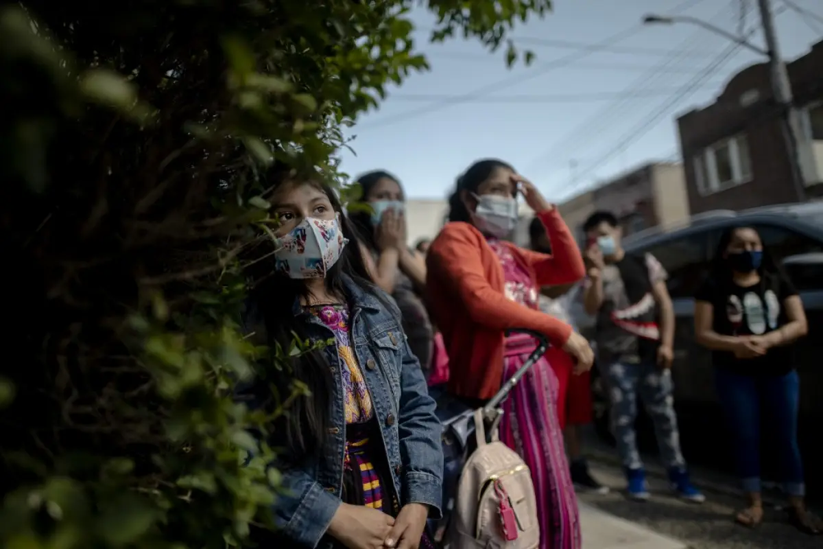 Fabian Arias (not pictured), a Lutheran pastor with Saint Peter's Church in Manhattan,  holds a service on the street in Brooklyn, for a group of immigrants from Guatemala on May 30, 2020 in New York City. - His church has lost more than 40 parishioners t