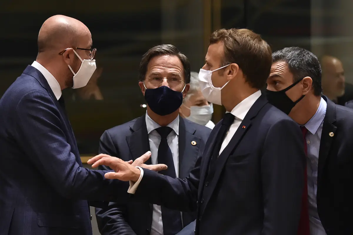 (FromL) European Council President Charles Michel, Netherlands' Prime Minister Mark Rutte, France's President Emmanuel Macron and Spain's Prime Minister Pedro Sanchez, all wearing a protective face mask, chat during an EU summit in Brussels on July 20, 20