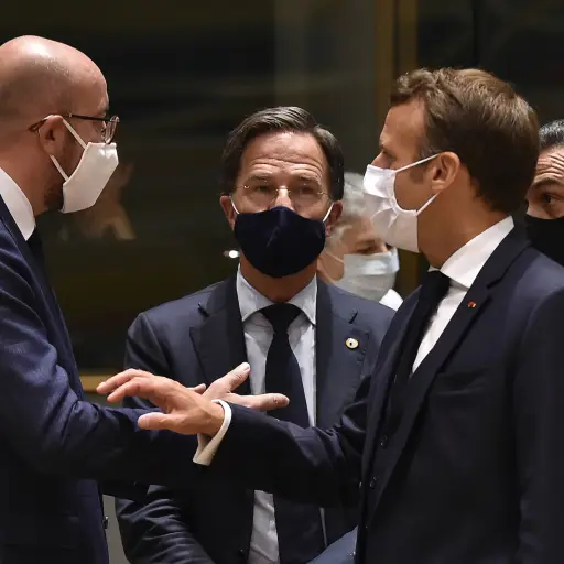(FromL) European Council President Charles Michel, Netherlands' Prime Minister Mark Rutte, France's President Emmanuel Macron and Spain's Prime Minister Pedro Sanchez, all wearing a protective face mask, chat during an EU summit in Brussels on July 20, 20