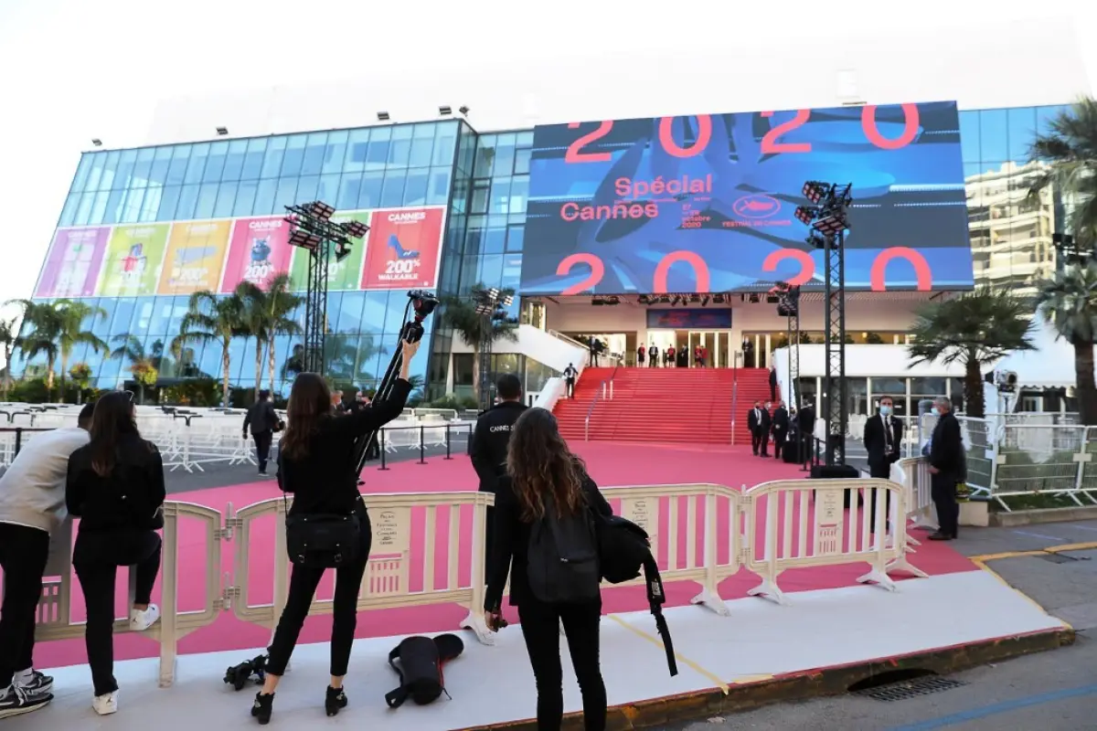 Journalists set up their gear near a red carpet outside the Palais des Festivals et des Congres ahead of Cannes 2020 Special, a mini-version of the Cannes Film Festival, on October 27, 2020, in Cannes, southeastern France. - Cannes 2020 Special, held amid