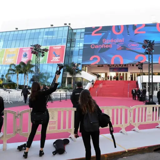 Journalists set up their gear near a red carpet outside the Palais des Festivals et des Congres ahead of Cannes 2020 Special, a mini-version of the Cannes Film Festival, on October 27, 2020, in Cannes, southeastern France. - Cannes 2020 Special, held amid