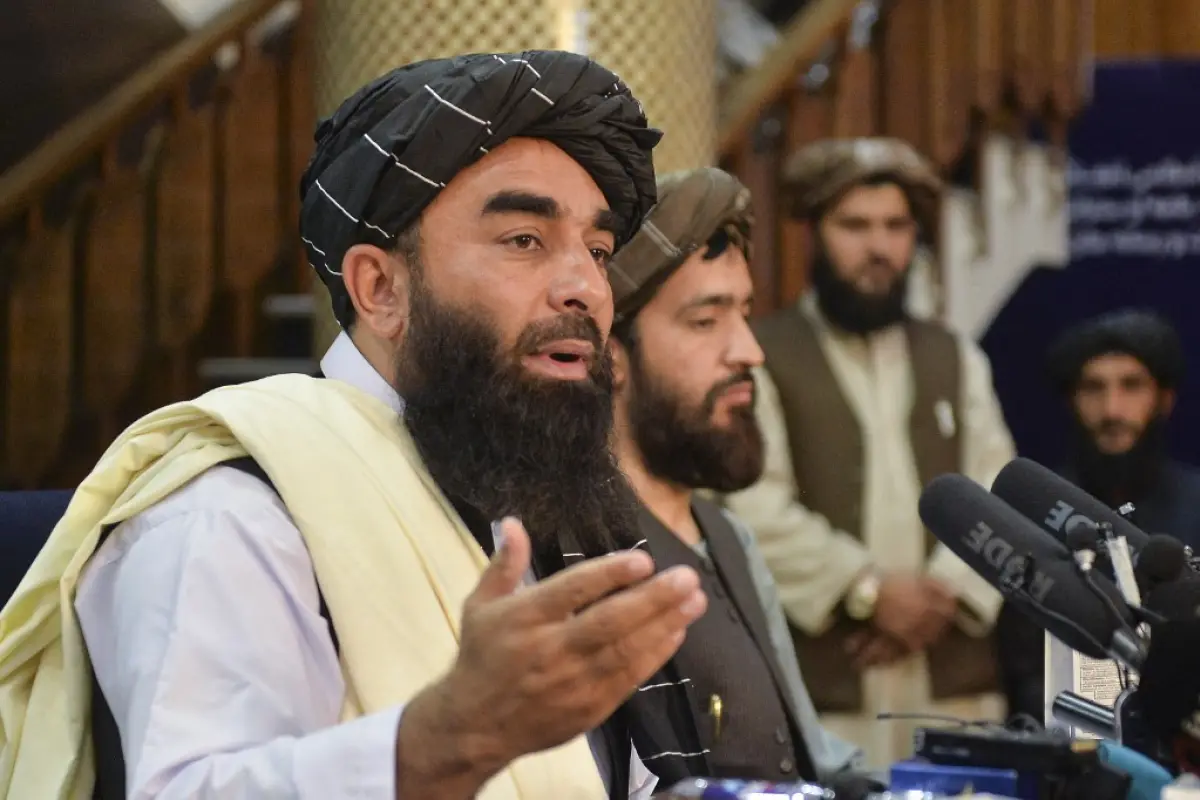 Taliban spokesperson Zabihullah Mujahid (L) gestures as he speaks during the first press conference in Kabul on August 17, 2021 following the Taliban stunning takeover of Afghanistan. (Photo by Hoshang Hashimi / AFP)