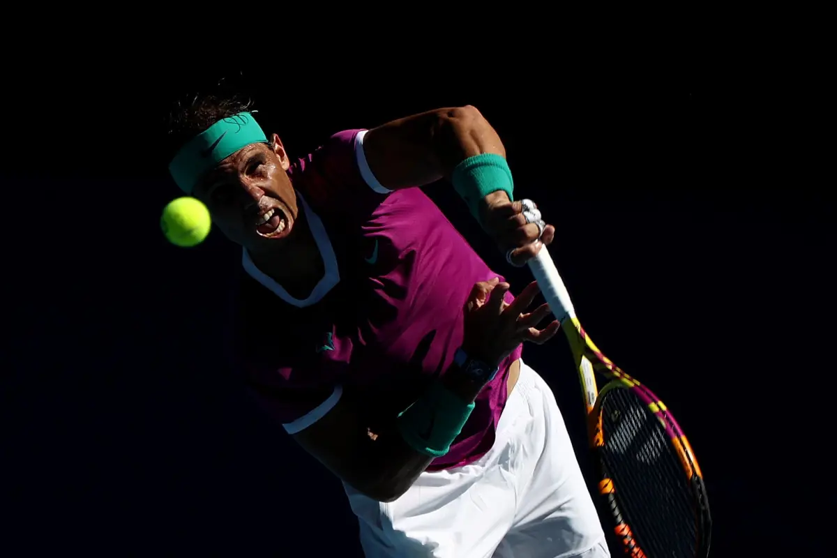 MELBOURNE, AUSTRALIA - JANUARY 25: Rafael Nadal of Spain serves in his Men's Singles Quarterfinals match against Denis Shapovalov of Canada during day nine of the 2022 Australian Open at Melbourne Park on January 25, 2022 in Melbourne, Australia. (Photo b