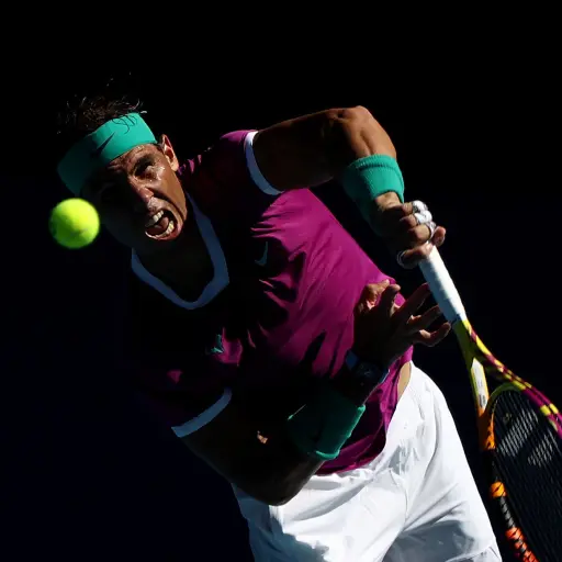 MELBOURNE, AUSTRALIA - JANUARY 25: Rafael Nadal of Spain serves in his Men's Singles Quarterfinals match against Denis Shapovalov of Canada during day nine of the 2022 Australian Open at Melbourne Park on January 25, 2022 in Melbourne, Australia. (Photo b