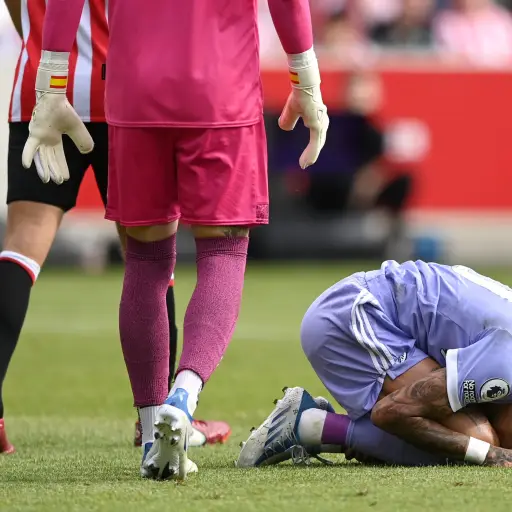 BRENTFORD, ENGLAND - MAY 22: Raphinha of Leeds United goes down after being fouled by David Raya of Brentford leading to a penalty being awarded during the Premier League match between Brentford and Leeds United at Brentford Community Stadium on May 22, 2