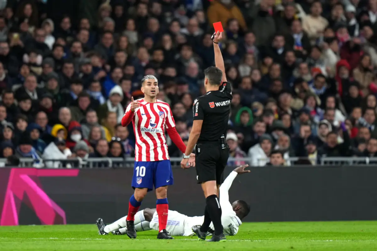 MADRID, SPAIN - FEBRUARY 25: Angel Correa of Atletico Madrid is shown a red card by Match Referee Jesus Gil Manzano during the LaLiga Santander match between Real Madrid CF and Atletico de Madrid at Estadio Santiago Bernabeu on February 25, 2023 in Madrid