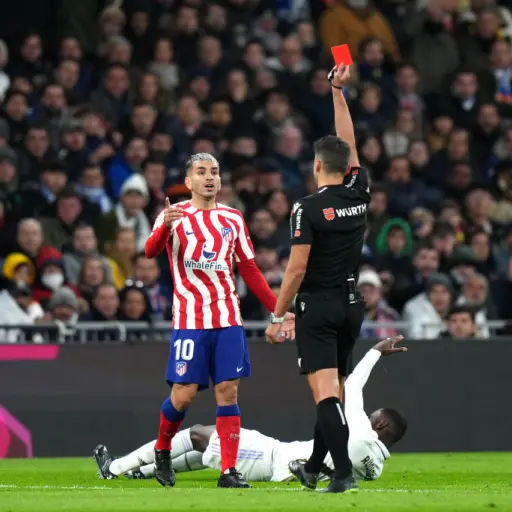 MADRID, SPAIN - FEBRUARY 25: Angel Correa of Atletico Madrid is shown a red card by Match Referee Jesus Gil Manzano during the LaLiga Santander match between Real Madrid CF and Atletico de Madrid at Estadio Santiago Bernabeu on February 25, 2023 in Madrid
