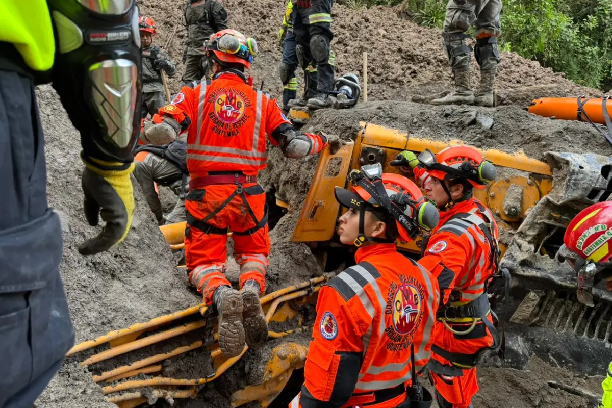 Los socorristas trabajan con herramientas para extraer el cuerpo de la tercera persona localizada debido a que se encuentra dentro de la cabina de una retroexcavadora. Foto: Bomberos Voluntarios