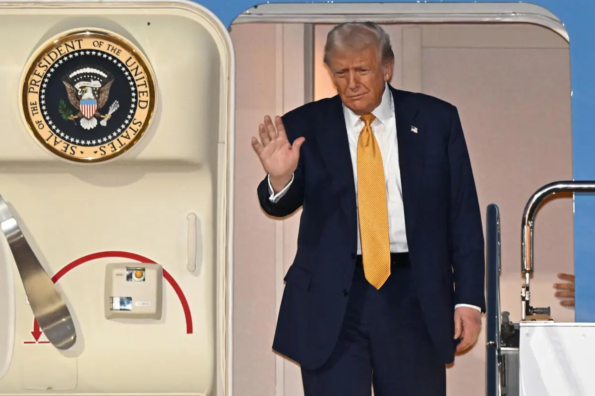Donald Trump saluda al descender del avión presidencial, EFE