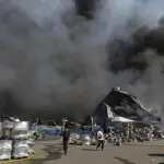 Vecinos caminan en el lugar de un ataque ruso a un almacén de mercancías cerca de Kiev, Ucrania, el 29 de agosto de 2026, en medio de la invasión rusa , Al menos 27 personas murieron y otras 42 resultaron heridas, incluidos 4 niños, como resultado de los bombardeos rusos durante la noche en Kiev y sus alrededores, según el jefe de la administración militar regional, Tymur Tkachenko